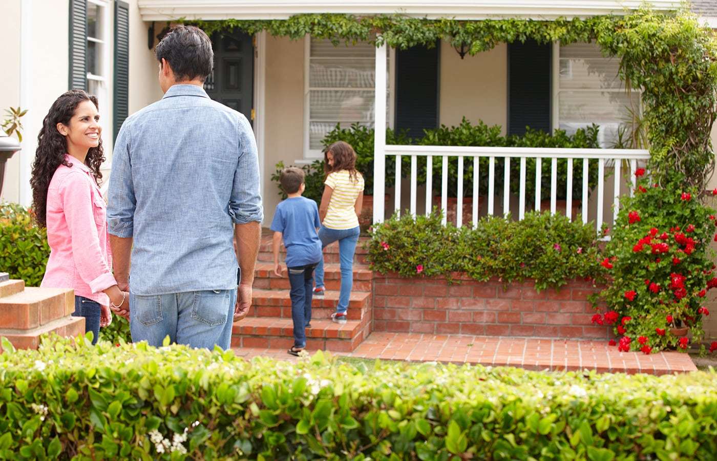 Mom smiling at dad while kids walk inside