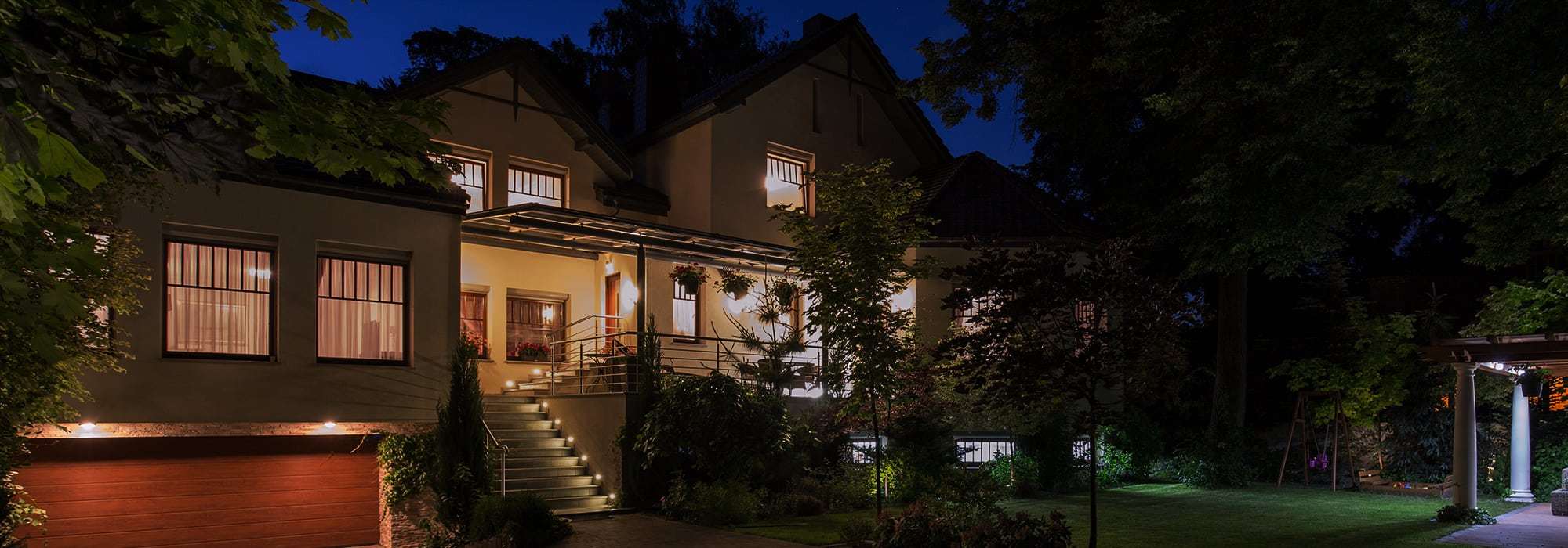 family home lit up at night