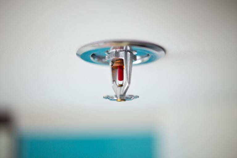 Closeup of sprinkler on ceiling